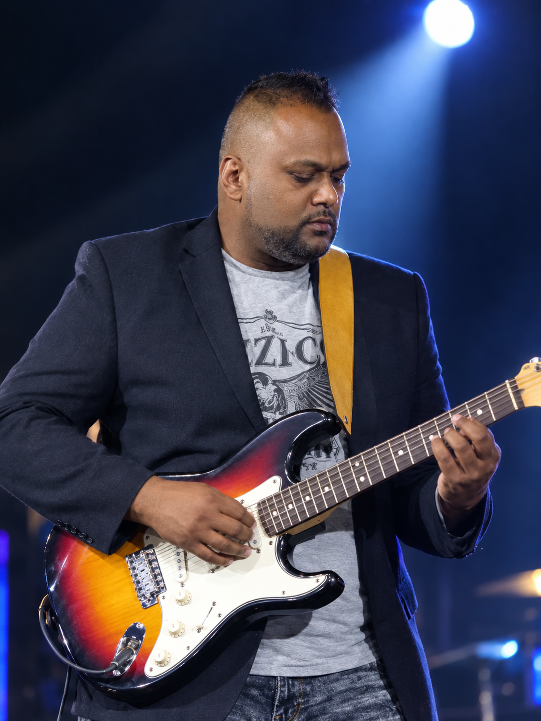 Jordan Govender playing electric guitar on stage